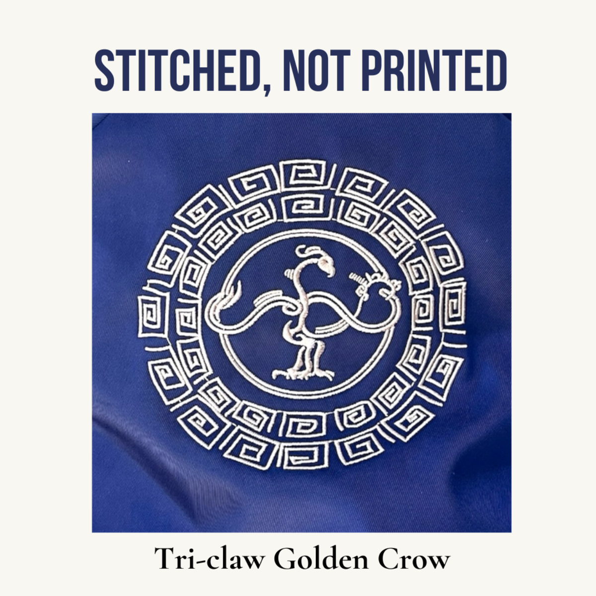 A square product graphic showing a blue fabric item with a golden embroidered circular motif featuring a tree feet crow and geometric border. Large text above reads 'STITCHED, NOT PRINTED' and text below reads 'Tri-claw Golden Crow'.
